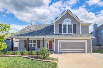 Front of property with a garage, a porch, and a front yard | Image 1