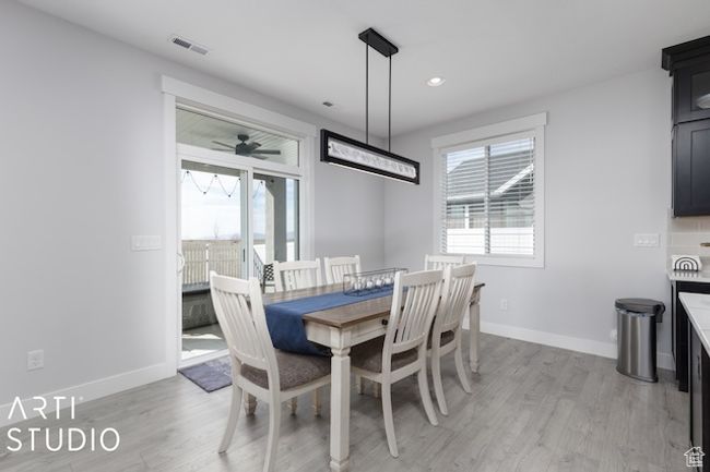 Dining space featuring visible vents, light wood-style flooring, baseboards, and ceiling fan | Image 15