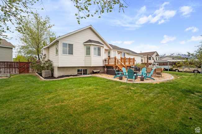 Back of property featuring a lawn, a deck, a patio area, and fence | Image 27
