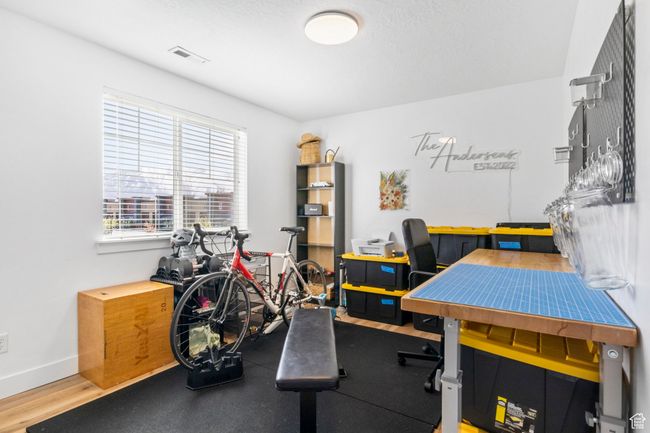Office space featuring visible vents, baseboards, and wood finished floors | Image 24