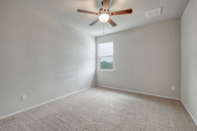 Carpeted spare room featuring ceiling fan and baseboards | Image 24