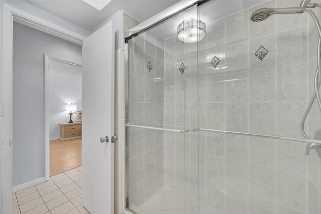 Your Bathroom Has an Updated Glass Enclosed Shower, Huge Custom Mirror, Built-In Hamper, Wall Heater and lots of Storage Cabinets and Countertops. | Image 47
