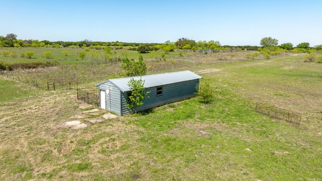 Details with a rural view, metal roof, fence, and a pole building | Image 27