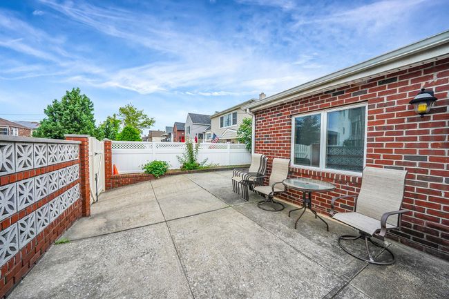 Fenced backyard with a patio | Image 4