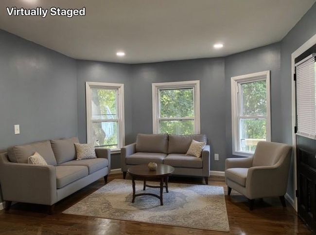 Living area featuring plenty of natural light, wood finished floors, and recessed lighting | Image 4