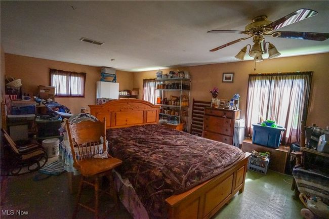 Bedroom featuring visible vents and a ceiling fan | Image 13