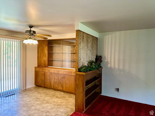 Dining area with built in shelves and china cabinet and convenient access to back yard | Image 4