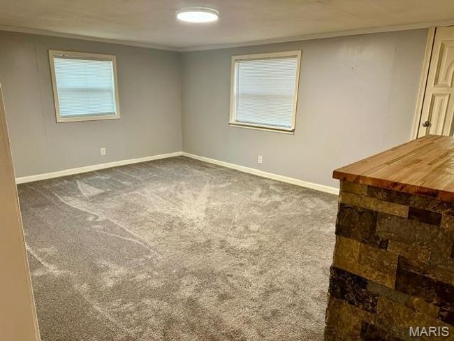 Spare room with dark carpet and ornamental molding | Image 22