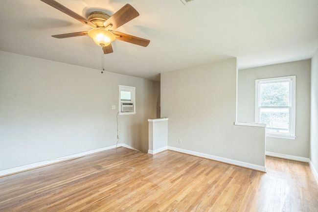 Spare room with plenty of natural light, light wood-type flooring, a ceiling fan, and cooling unit | Image 14