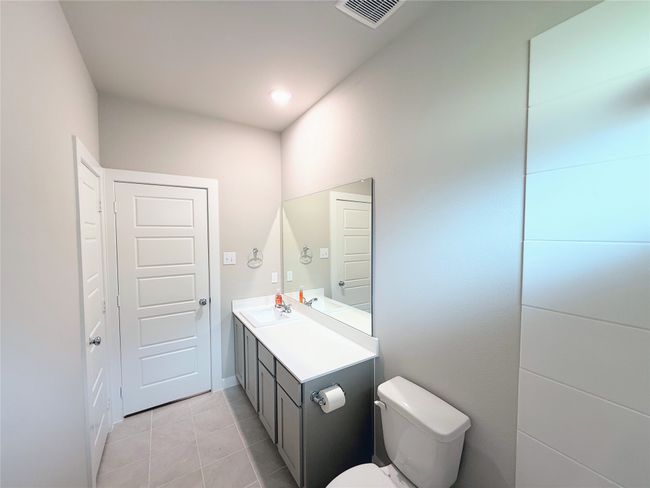 Half bathroom with toilet, vanity, and tile patterned floors | Image 20