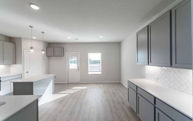 Kitchen featuring gray cabinetry, backsplash, light wood-style floors, light countertops, and recessed lighting | Image 9