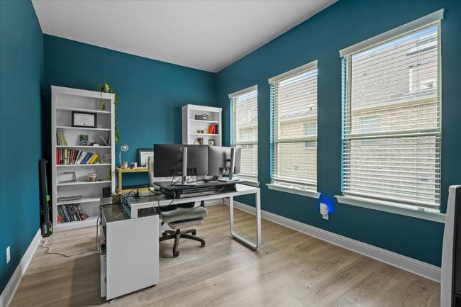 Office area with wood finished floors and baseboards | Image 15