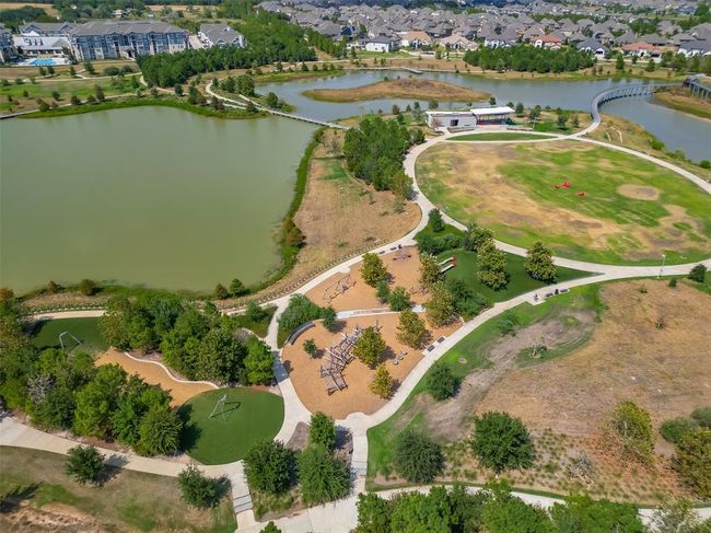 Features a single-family home with a spacious yard in Bridgeland, a master-planned community offering lakes, pools, sidewalks, and green spaces. | Image 35