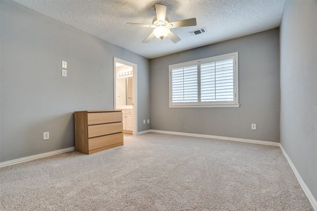Spare room featuring ceiling fan, a textured ceiling, light carpet, and baseboards | Image 18
