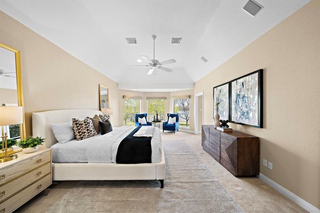 The room's high, tray ceilings and expansive arched windows fill the space with an abundance of natural light, enhancing both the room's ambiance and the scenic vistas beyond. | Image 23