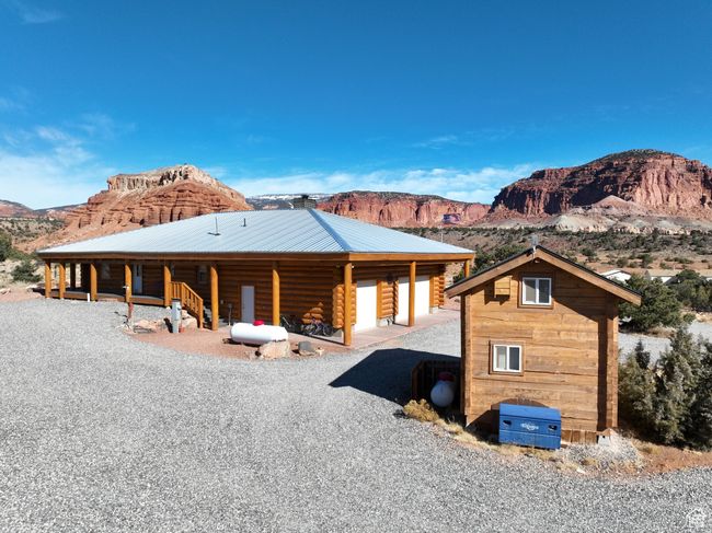 Back of house featuring log siding, a mountain view, metal roof, and an outbuilding | Image 22