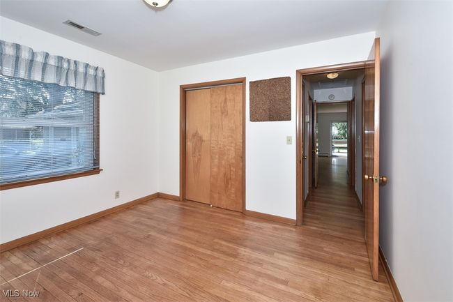 Unfurnished bedroom with a closet, light wood-style flooring, visible vents, and baseboards | Image 36