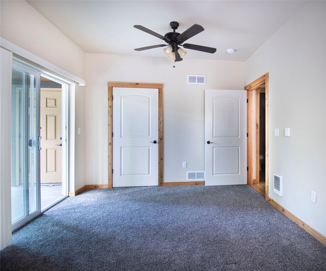 Unfurnished bedroom with carpet, ceiling fan, and access to outside | Image 18