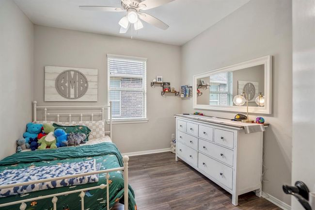 This bright third bedroom features easy-to-care-for vinyl plank floors and a large window that fills the space with natural light — a welcoming spot for rest or work. | Image 29