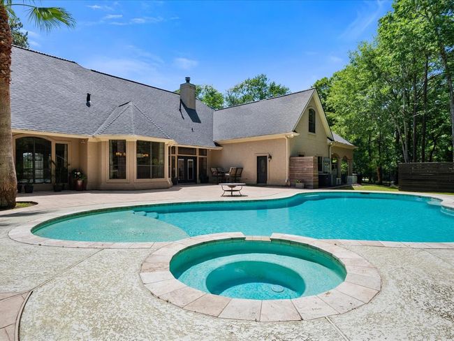 A view from the spa highlights how seamlessly this home blends indoor comfort with outdoor fun—just steps from the back door. | Image 41