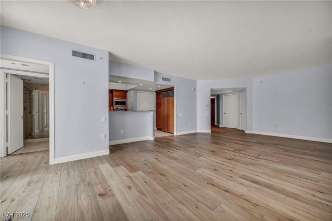 Unfurnished living room with baseboards, visible vents, and light wood-style floors | Image 20