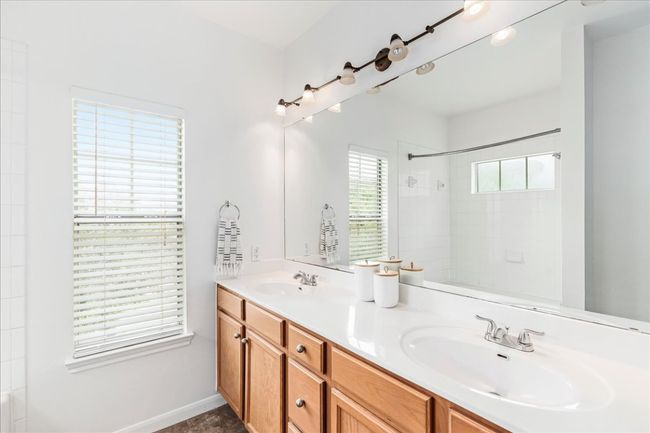 The primary ensuite features a dual vanity. | Image 20
