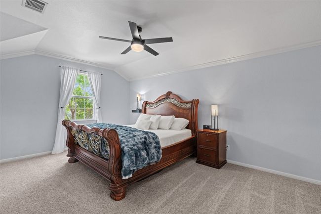 Carpeted bedroom with lofted ceiling, baseboards, and ceiling fan | Image 24