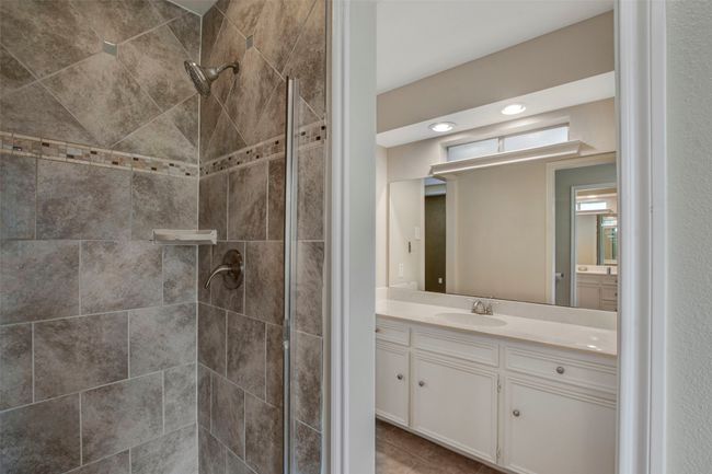 Full bathroom featuring a shower stall and vanity | Image 9