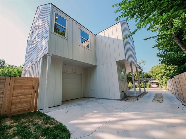 View of front of property with an attached garage, board and batten siding, and driveway | Image 4