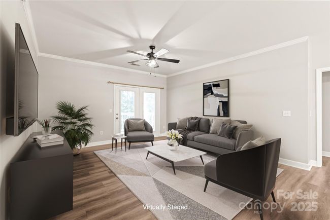 Open living room in the heart of the home. Plenty of room and steps away from your balcony facing a wooded area. | Image 5