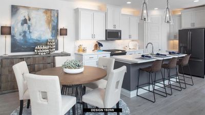 Kitchen featuring light hardwood / wood-style flooring, a center island with sink, black fridge, backsplash, and sink | Image 3