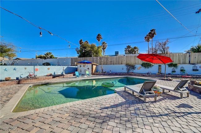 View of pool with a fenced backyard and a patio | Image 10