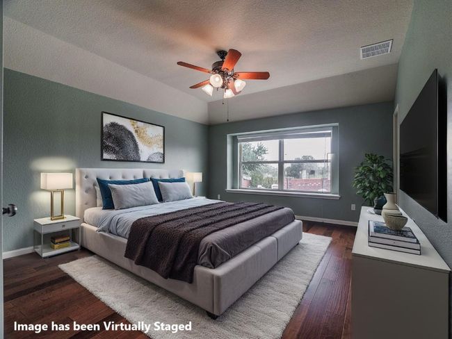 Bedroom featuring dark wood-style floors, a textured ceiling, vaulted ceiling, a textured wall, and ceiling fan | Image 26