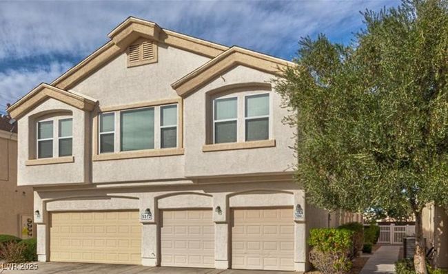 View of front facade with stucco siding, concrete driveway, and an attached garage | Image 22