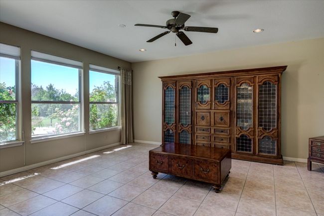 This spacious flex room off the breakfast area could be a family room, or creative space. | Image 10