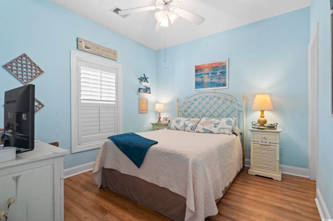 Bedroom featuring baseboards, visible vents, ceiling fan, and wood finished floors | Image 6