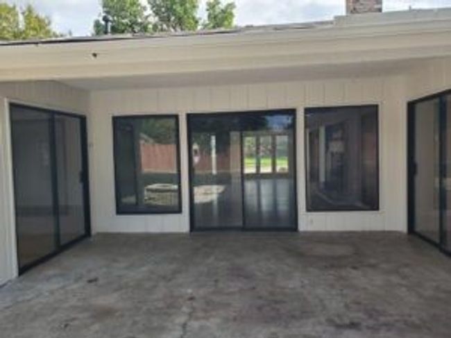 Doorway to property with a chimney and a carport | Image 4