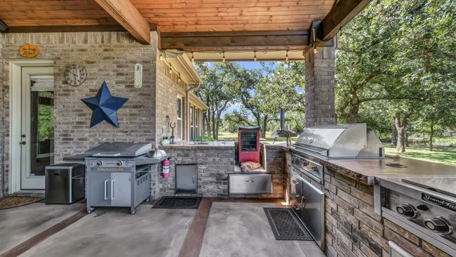 View of patio with an outdoor kitchen | Image 38