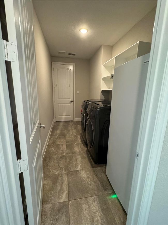 Laundry area with washer and dryer and baseboards | Image 40
