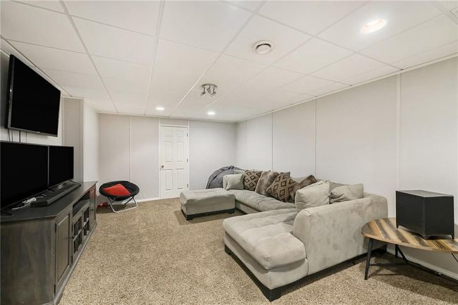 Living room with carpet floors, a drop ceiling, and recessed lighting | Image 17