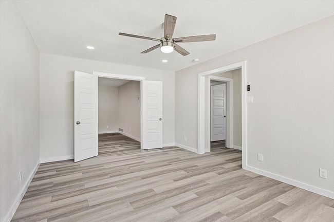 Unfurnished bedroom featuring recessed lighting, light wood finished floors, a ceiling fan, and baseboards | Image 15