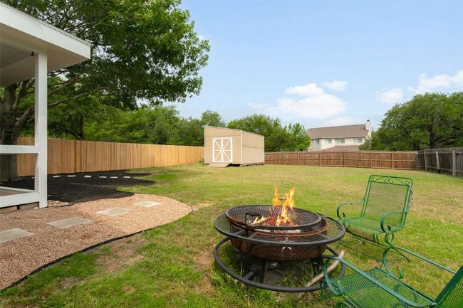 Spacious backyard featuring a cozy outdoor fire pit—ideal for entertaining! | Image 38