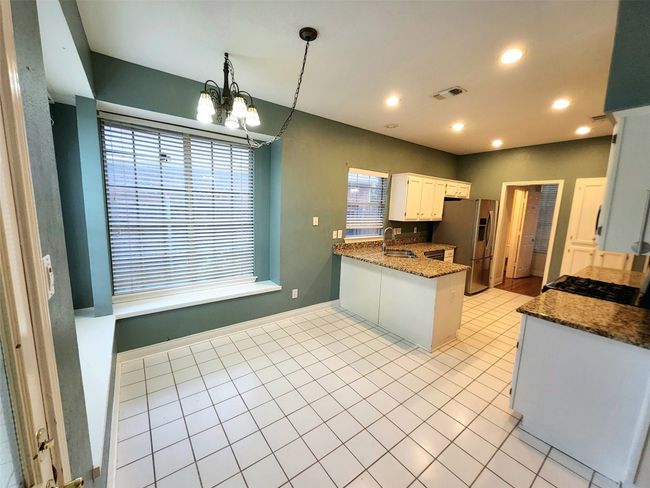 Kitchen with gas Range, granite, stainless appliances | Image 9