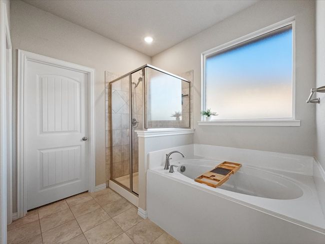 Full bath with tile patterned flooring, a garden tub, and a stall shower | Image 15