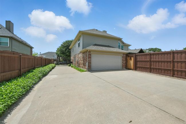 This large drive way is protected by an automated gate. | Image 33