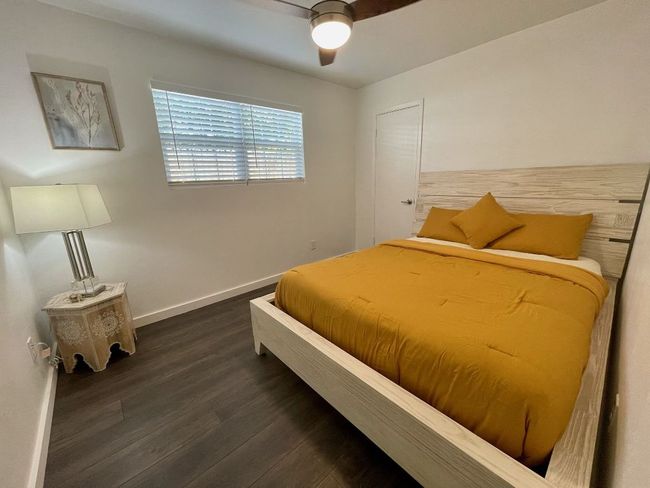 Bedroom featuring wood finished floors and ceiling fan | Image 7