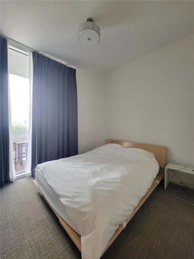 Bedroom with carpet flooring and access to outside | Image 11