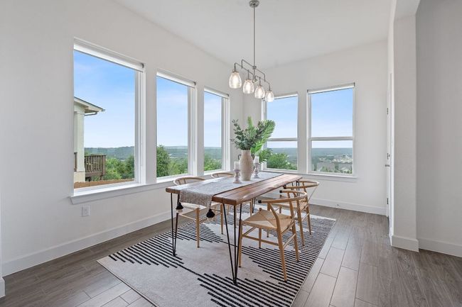 The spacous dining area is nestled in oversized corner windows where you can enjoy meals with an absolutely spectacular hill country backdrop. | Image 5