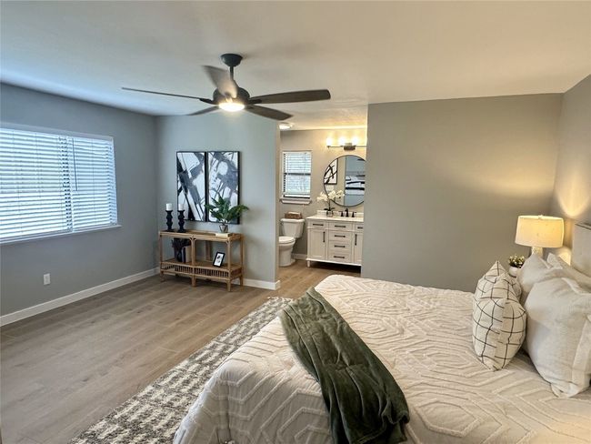 Primary Bedroom featuring hard tile floors, ensuite bathroom, and ceiling fan | Image 12