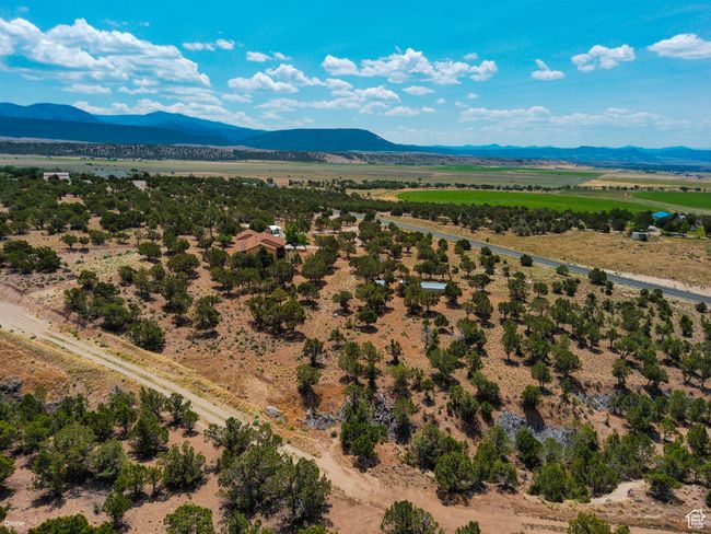 Aerial view of sparsely populated area with a mountainous background | Image 48